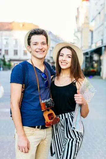 smiling-tourist-couple-city_23-2147828027 (1)